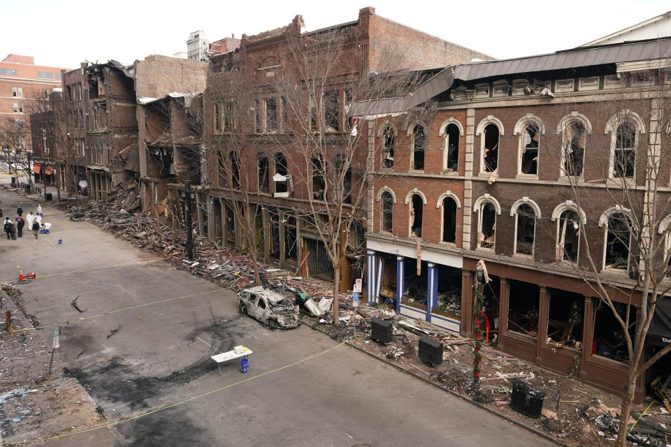 FILE - In this Tuesday, Dec. 29, 2020 file photo, debris remains on the sidewalks in front of buildings damaged in a Christmas Day explosion in Nashville, Tenn. On Thursday, Dec. 31, 2020, The Associated Press reported on stories circulating online incorrectly asserting the explosion was caused by a missile or some kind of directed energy weapon. Surveillance video from a Metro Nashville Police Department camera at the intersection of 2nd Avenue North and Commerce Street captured the explosion and offers proof that the blast came from a parked recreational vehicle. (AP Photo/Mark Humphrey)