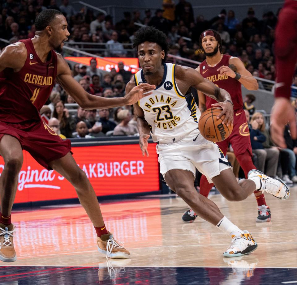 Indiana Pacers forward Aaron Nesmith (23) drives past Cleveland Cavaliers forward Evan Mobley (4) on Thursday, Dec. 29, 2022, at Gainbridge Fieldhouse in Indianapolis. 