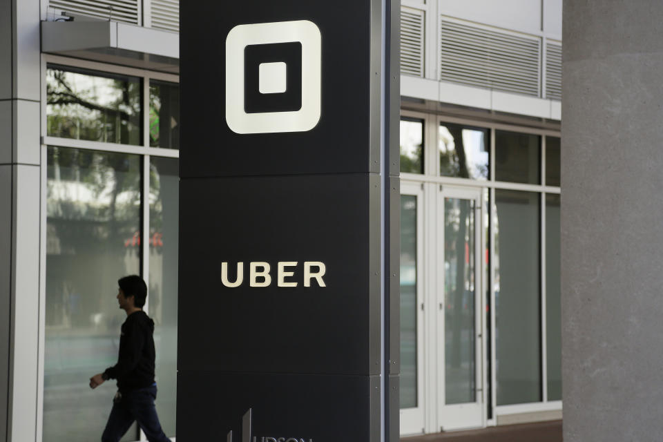 FILE- In this June 21, 2017, file photo a man walks into the building that houses the headquarters of Uber in San Francisco. Documents released Thursday, April 11, 2019, offered the most detailed view of the world’s largest ride-hailing service since its inception a decade ago. (AP Photo/Eric Risberg, File)