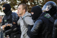 Police detain a man during a mass protest following presidential elections in Minsk, Belarus, Monday, Aug. 10, 2020. Thousands of people have protested in Belarus for a second straight night after official results from weekend elections gave an overwhelming victory to authoritarian President Alexander Lukashenko, extending his 26-year rule. A heavy police contingent blocked central squares and avenues, moving quickly to disperse protesters and detained dozens. (AP Photo/Sergei Grits)