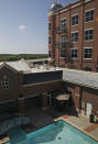 In this Sept. 17, 2019 photo, a swimming pool at the Artesian Hotel, Casino & Spa, a four-story hotel and spa, is pictured in Sulphur, Okla. In downtown Sulphur, 90 minutes south of Oklahoma City, the Chickasaw Nation built the hotel and spa that hosts prom night for half a dozen area high schools. (AP Photo/Sue Ogrocki)