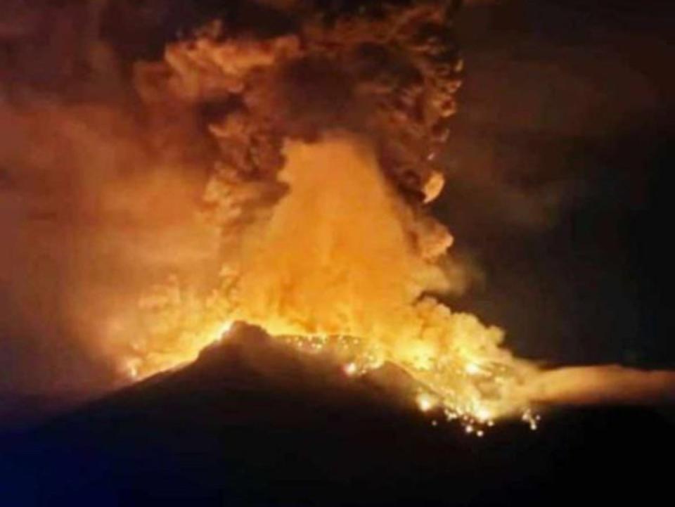 A handout photo made available by Indonesian Center for Volcanology and Geological Hazard Mitigation shows smoke an lava erupting from Mount Ruang (EPA)