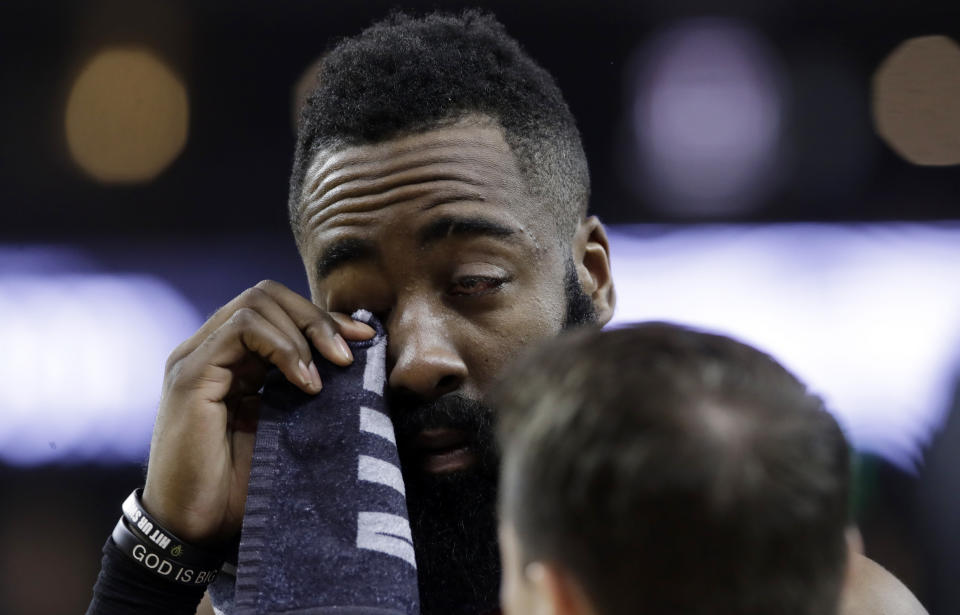 Houston Rockets' James Harden wipes his injured eye with a towel during the first half of Game 2 of the team's second-round NBA basketball playoff series against the Golden State Warriors in Oakland, Calif., Tuesday, April 30, 2019. (AP Photo/Jeff Chiu)