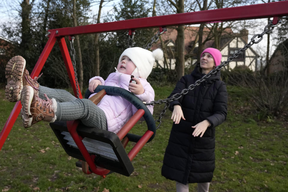 Viktoria Kovalenko and her daughter Varvara enjoy the swing in a village in Kent, Thursday, Feb. 9, 2023. Kovalenko chose to come to England not only because it offered her refuge from the war in Ukraine. It was also a chance for her to escape from her harrowing memories of losing her family in a shell attack. (AP Photo/Frank Augstein)