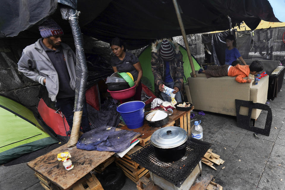 Migrants camp in tents outside the Church of Santa Cruz y La Soledad in Mexico City, Tuesday, Dec. 26, 2023. (AP Photo/Marco Ugarte)