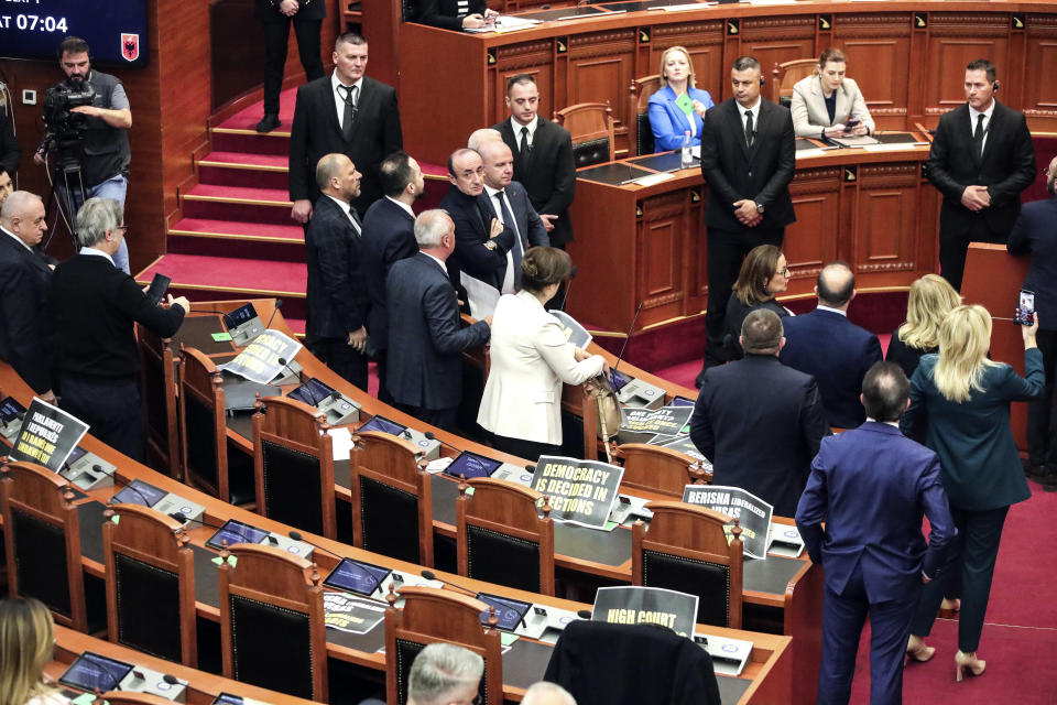 Lawmakers of the Democratic Party look on as their colleagues of the ruling Socialist party vote in Tirana, Albania, Thursday, Feb. 22, 2024. Albania’s Parliament on Thursday approved a deal for the country to hold thousands of migrants rescued in international waters by Italy while their asylum applications are processed, despite protests from opposition lawmakers and human rights groups. (AP Photo/Armando Babani)