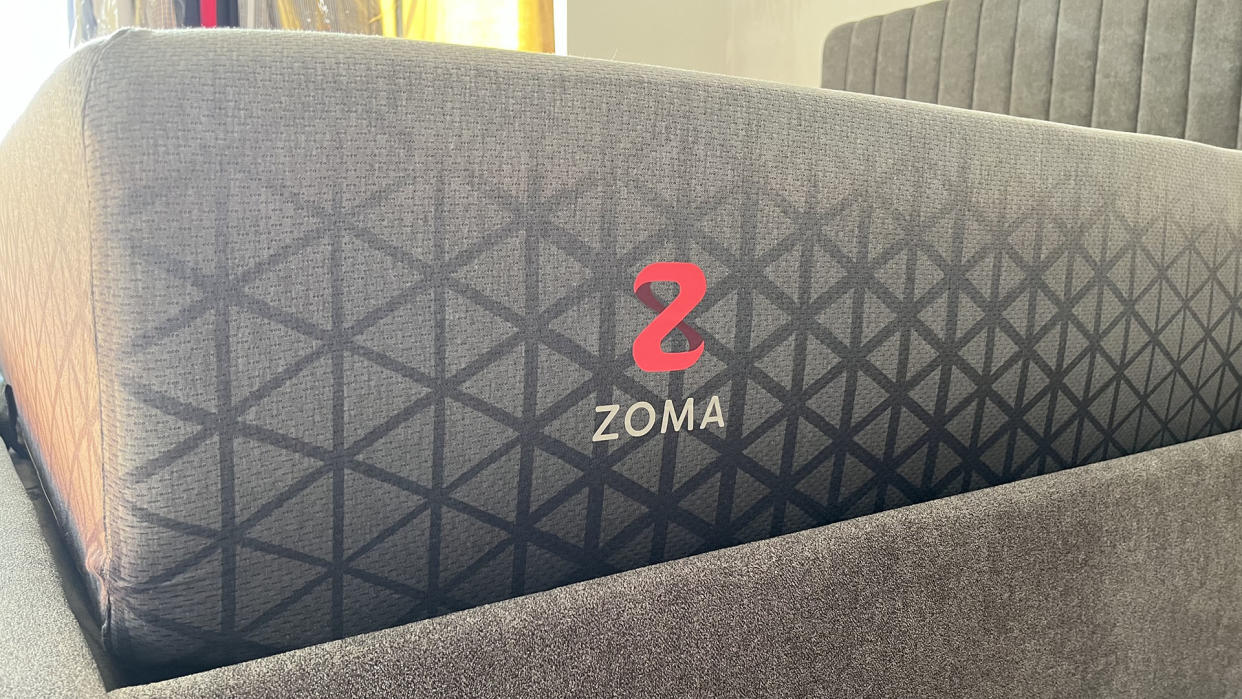  Zoma Hybrid mattress photographed from the side in reviewer's bedroom. 