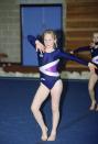 <p>Zara performs a gymnastics routine in front of very special guests—her grandparents. Queen Elizabeth and Prince Philip paid a visit to her school, Port Regis, to watch her compete.</p>