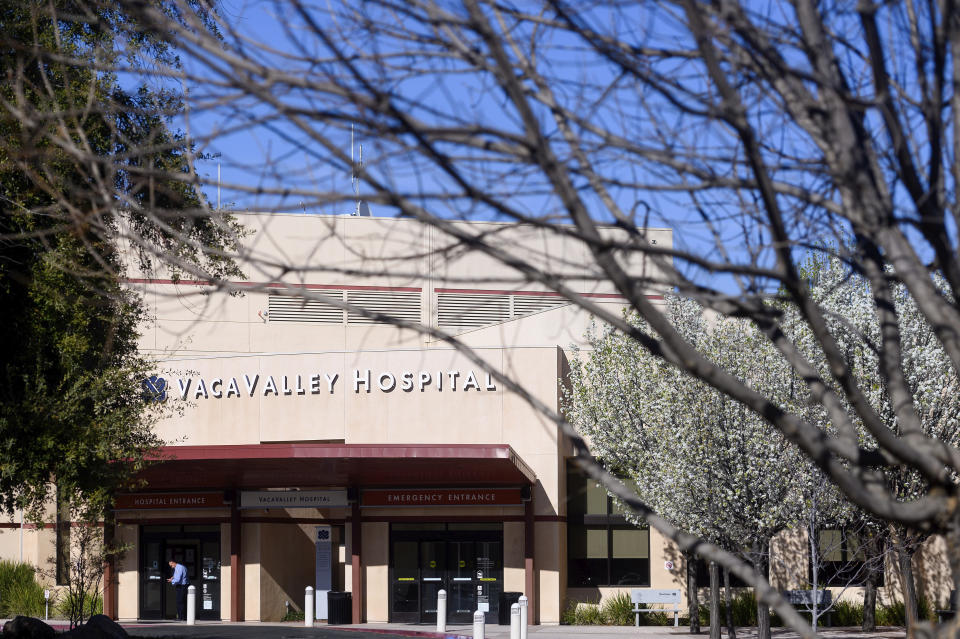 A person enters NorthBay VacaValley Hospital, where a woman diagnosed with coronavirus previously sought treatment, on Thursday, Feb. 27, 2020, in Vacaville, Calif. Health officials believe she is first person in the U.S. diagnosed with the highly contagious coronavirus without traveling abroad or coming in close contact with an international traveler. (AP Photo/Noah Berger)