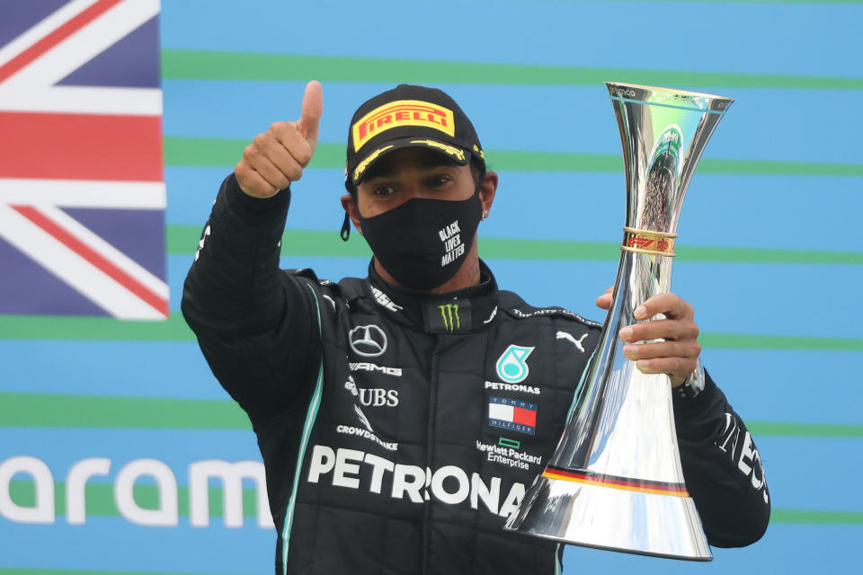 NUERBURG, GERMANY - OCTOBER 11: Race winner Lewis Hamilton of Great Britain and Mercedes GP celebrates on the podium during the F1 Eifel Grand Prix at Nuerburgring on October 11, 2020 in Nuerburg, Germany. (Photo by Wolfgang Rattay - Pool/Getty Images)