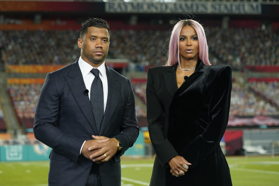 Seattle Seahawks quarterback Russell Wilson and his wife Ciara talk make a statement after Wilson won the Walter Payton NFL Man of the Year awards at the NFL Honors ceremony as part of Super Bowl 55 Friday, Feb. 5, 2021, in Tampa, Fla. (AP Photo/Charlie Riedel)