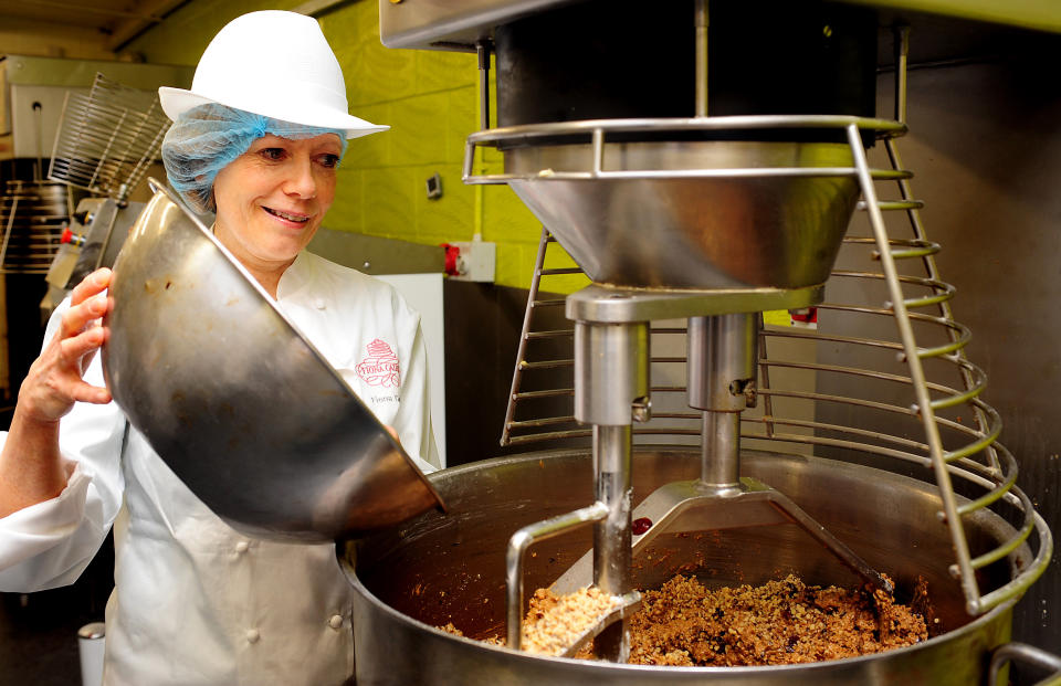 Cake designer Fiona Cairns, who has been commissioned by Britain's Prince William and his fiancee Kate Middleton to create a traditional fruit cake for their wedding, mixes ingredients in Fleckney, Leicestershire, on March 24, 2011. The cake will be decorated with William and Kate's new cipher and will be lavishly decorated with a floral theme. Britain's Prince William, the second in line to the throne, and Kate Middleton announced their engagement in November 2010 after a seven-year romance that began at university. The wedding, at Westminster Abbey on April 29 in London, is set to be Britain's biggest royal wedding since William's parents, Prince Charles and Lady Diana Spencer, married in 1981. April 29 has been made a public holiday throughout the kingdom. AFP PHOTO / RUI VIEIRA / WPA POOL (Photo credit should read RUI VIEIRA/AFP via Getty Images)