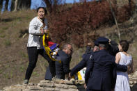 Police officers detain protesters displaying a Tibetan flag and a banner disrupting the lighting of the Olympic flame at Ancient Olympia site, birthplace of the ancient Olympics in southwestern Greece, Monday, Oct. 18, 2021. The flame will be transported by torch relay to Beijing, China, which will host the Feb. 4-20, 2022 Winter Olympics. (AP Photo/Thanassis Stavrakis)