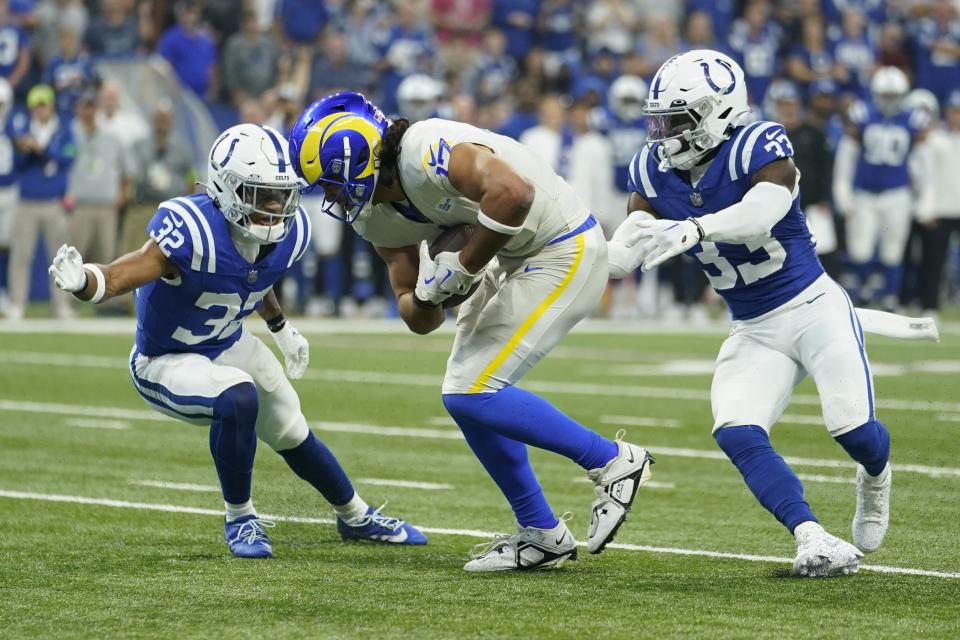 Los Angeles Rams wide receiver Puka Nacua, center, makes a catch as Indianapolis Colts safety Julian Blackmon, left, and cornerback Dallis Flowers defend during the first half of an NFL football game, Sunday, Oct. 1, 2023, in Indianapolis. | Michael Conroy, Associated Press