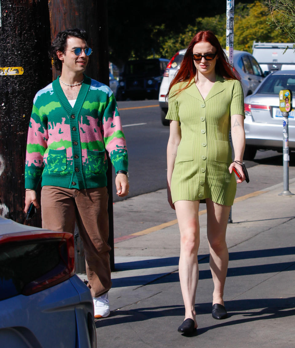 Sophie walks down the street with Joe