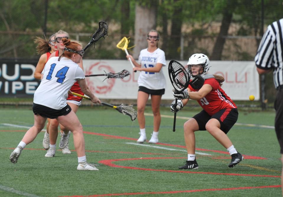 Quincy's Grace Connor's shot flies past North Quincy goalkeeper Cate Murray, right, during girls lacrosse at Veterans Stadium in Quincy, Tuesday, May 16, 2023.