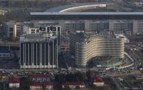 An aerial view from a helicopter shows the Sochi 2014 Organizing Committee headquarters (R) and the Russian Seasons Hotel Sochi in the Adler district of the Black Sea resort city of Sochi, December 23, 2013. Sochi will host the 2014 Winter Olympic Games in February. Picture taken December 23, 2013. REUTERS/Maxim Shemetov (RUSSIA - Tags: CITYSCAPE SPORT OLYMPICS TRAVEL)