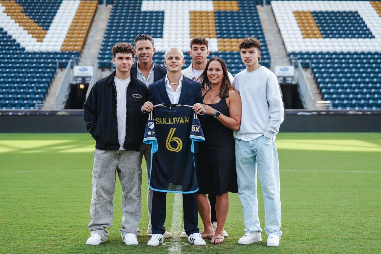 Cavan Sullivan, middle, a 14-year-old American soccer phenom signed a four-year deal with the Philadelphia Union in Major League Soccer on Thursday, May 9, 2024, poses for a photo with him family.