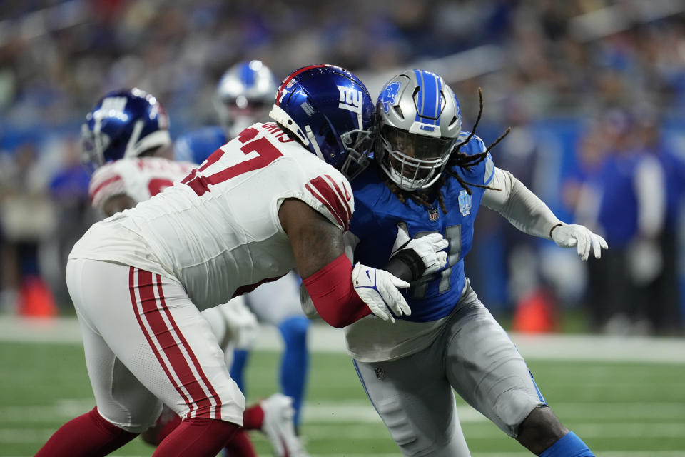 Detroit Lions linebacker James Houston (41) goes up against New York Giants guard Wyatt Davis (67) during the second half of an NFL preseason football game, Friday, Aug. 11, 2023, in Detroit. (AP Photo/Paul Sancya)