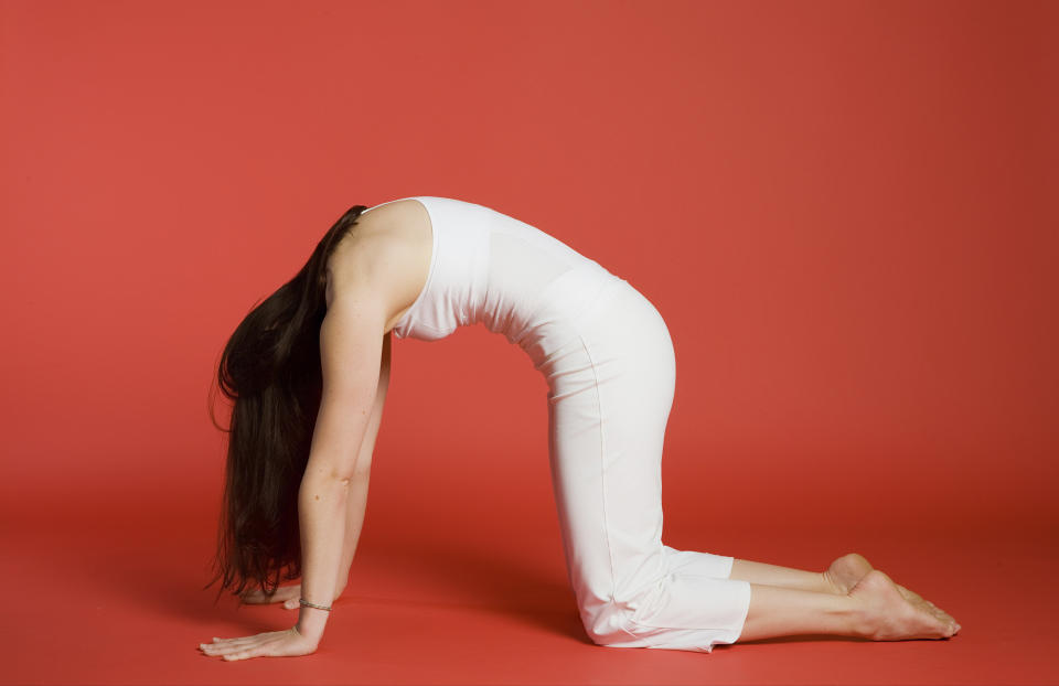 Cat-cow tilts can be an effective <a href="http://www.huffingtonpost.com/2013/08/15/yoga-for-headaches_n_3574848.html" target="_blank">headache reliever</a>, in addition to opening up the back and stretching the spine. Start with hands and knees on the floor in a tabletop position with a neutral spine. On the inhale, round the spine and curve up into your cat pose (pictured above). On the exhale, arch the back and lift the chest to come into a cow pose. Repeat three to five times, focusing on the breath.  "It also helps bring the neck back into the position over the spine -- people tend to protrude it forward, and this pose brings the vertebrae back to homeostasis," Bielkus says.