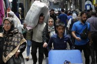 People conduct their business in the old main bazaar of Tehran, Iran, Thursday, June 13, 2024. The rise of the “Hamster Kombat” app in Iran highlights a harsher truth facing the Islamic Republic's economy ahead of its presidential election this week to replace the late President Ebrahim Raisi, who died in a helicopter crash in May. (AP Photo/Vahid Salemi)