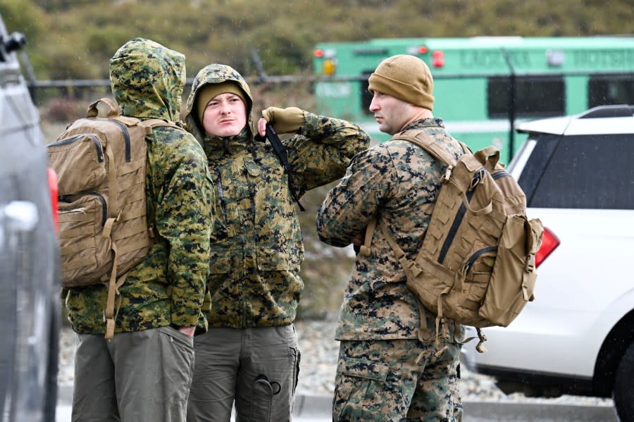 U.S. Marines wait to leave a command center, Wednesday, Feb. 7, 2024, in Kitchen Creek, Calif. A Marine Corps helicopter that had been missing with five troops aboard as an historic storm continued drenching California was found Wednesday morning in a mountainous area outside San Diego. (AP Photo/Denis Poroy)