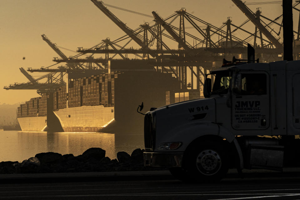 FILE - A truck arrives to pick up a shipping container near vessels moored at Maersk APM Terminals Pacific at the Port of Los Angeles, on Nov. 30, 2021. When President Joe Biden took office in 2021, he kept much of former President Trump’s combative trade policy in place, including the China tariffs. (AP Photo/Damian Dovarganes, File)