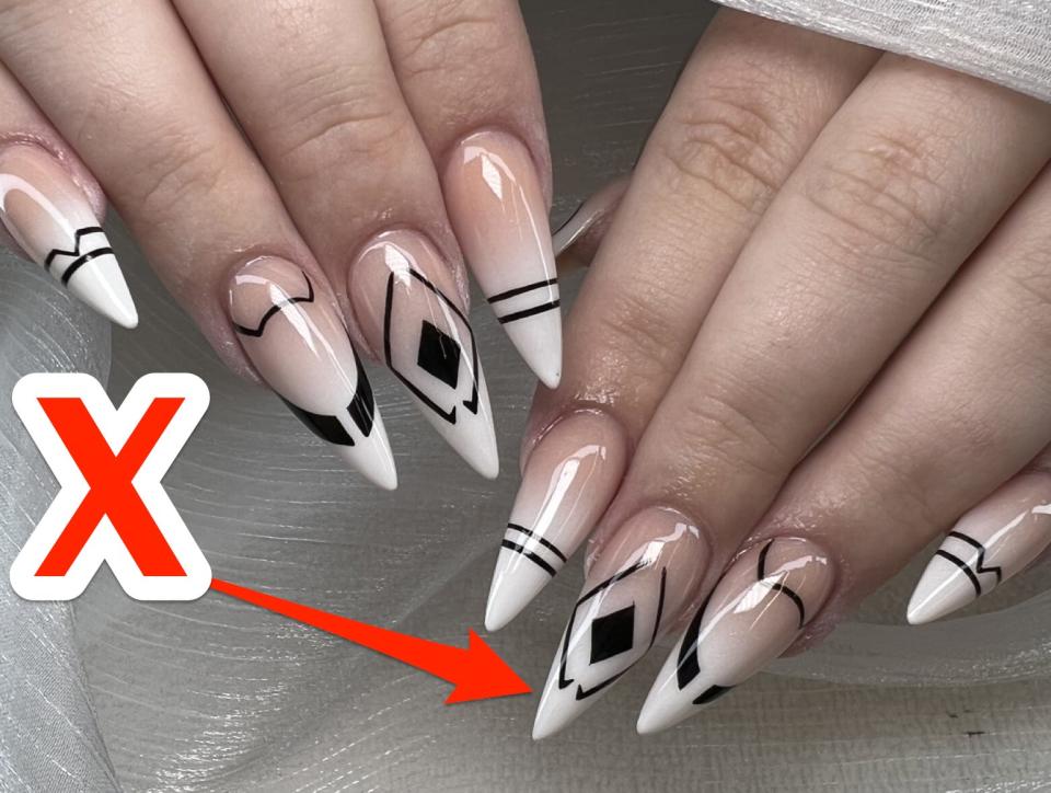 An X pointing at long, almond-shaped nails.