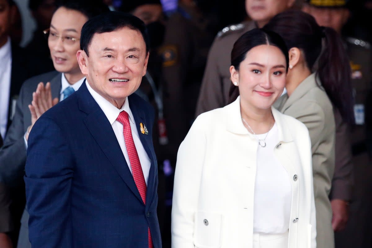 Former Thai prime minister Thaksin Shinawatra smiles next to his daughter and Pheu Thai Party prime ministerial candidate Paetongtarn Shinawatra (EPA)
