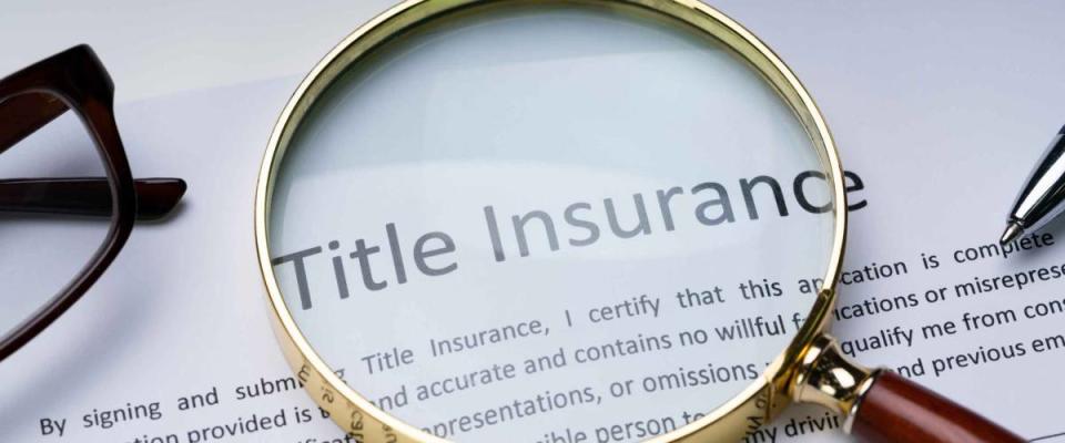 Magnifying Glass Over Title Insurance Form On Table