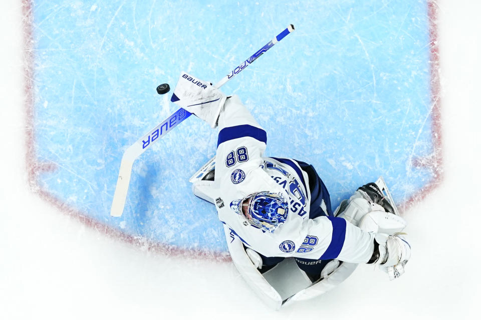 Tampa Bay Lightning goaltender Andrei Vasilevskiy (88) makes a save against the Colorado Avalanche during the first period in Game 5 of the NHL Stanley Cup Final on Friday, June 24, 2022, in Denver. (AP Photo/Jack Dempsey)