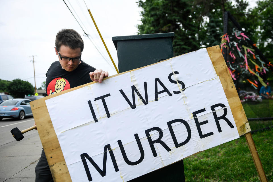 <p>Bob Edwards, of St. Anthony, uses a mallet Friday, June 16, 2017, in Falcon Heights, Minn., to install a sign he made near the site where Philando Castile was shot and killed during a traffic stop by St. Anthony police Officer Jeronimo Yanez last year. Yanez was cleared Friday in the fatal shooting of Castile, a black motorist whose death captured national attention when his girlfriend streamed the grim aftermath on Facebook. (Aaron Lavinsky/Star Tribune via AP) </p>