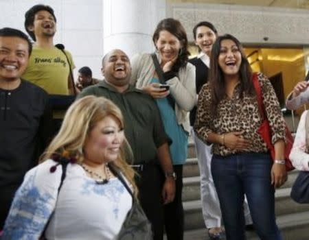 Activists celebrate overturning a sharia law against cross-dressing at the Appeals Court in the Palace of Justice in Putrajaya November 7, 2014. REUTERS/Olivia Harris