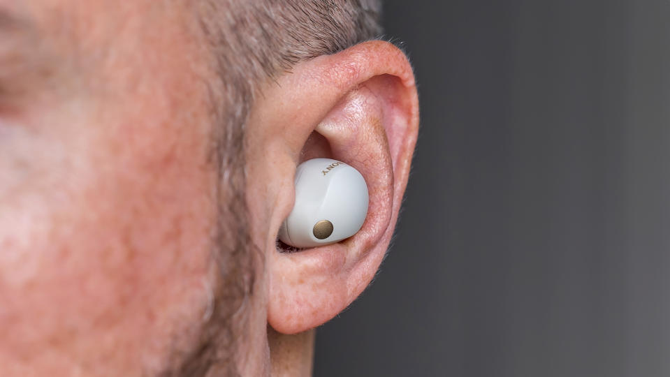 Close-up of Sony WF-1000XM5 earbuds in ear.