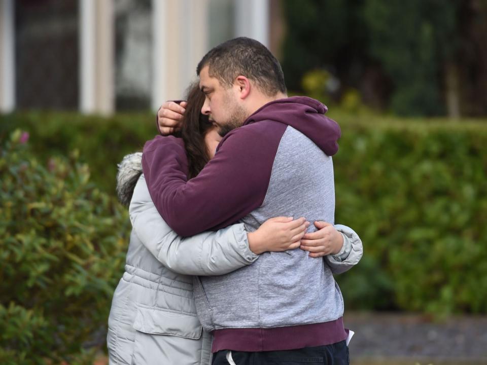 Reese Platt-May hugs his sister, Tia Fletcher, close to the scene the day after their deaths