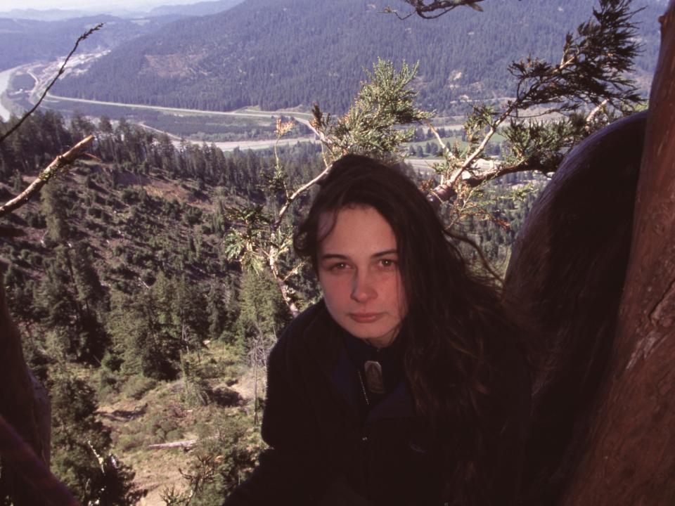 Environmental activist Julia Butterfly Hill sits in a redwood tree that she has been living in for ob=ver a year to prevent it from being harvested by the Pacific Lumber Company in April of 1998 in Stafford, California.