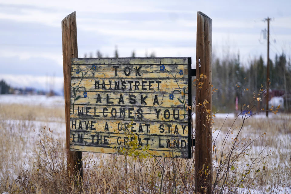 A welcome to Tok Mainstreet Alaska sign is shown Wednesday, Sept. 22, 2021, in Tok, Alaska. The state is experiencing one of the sharpest rises in COVID-19 cases in the country, coupled with a limited statewide healthcare system that is almost entirely reliant on Anchorage hospitals. (AP Photo/Rick Bowmer)