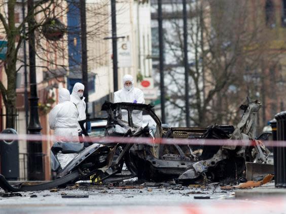 Forensic teams investigate the aftermath of the bombing (AFP/Getty)