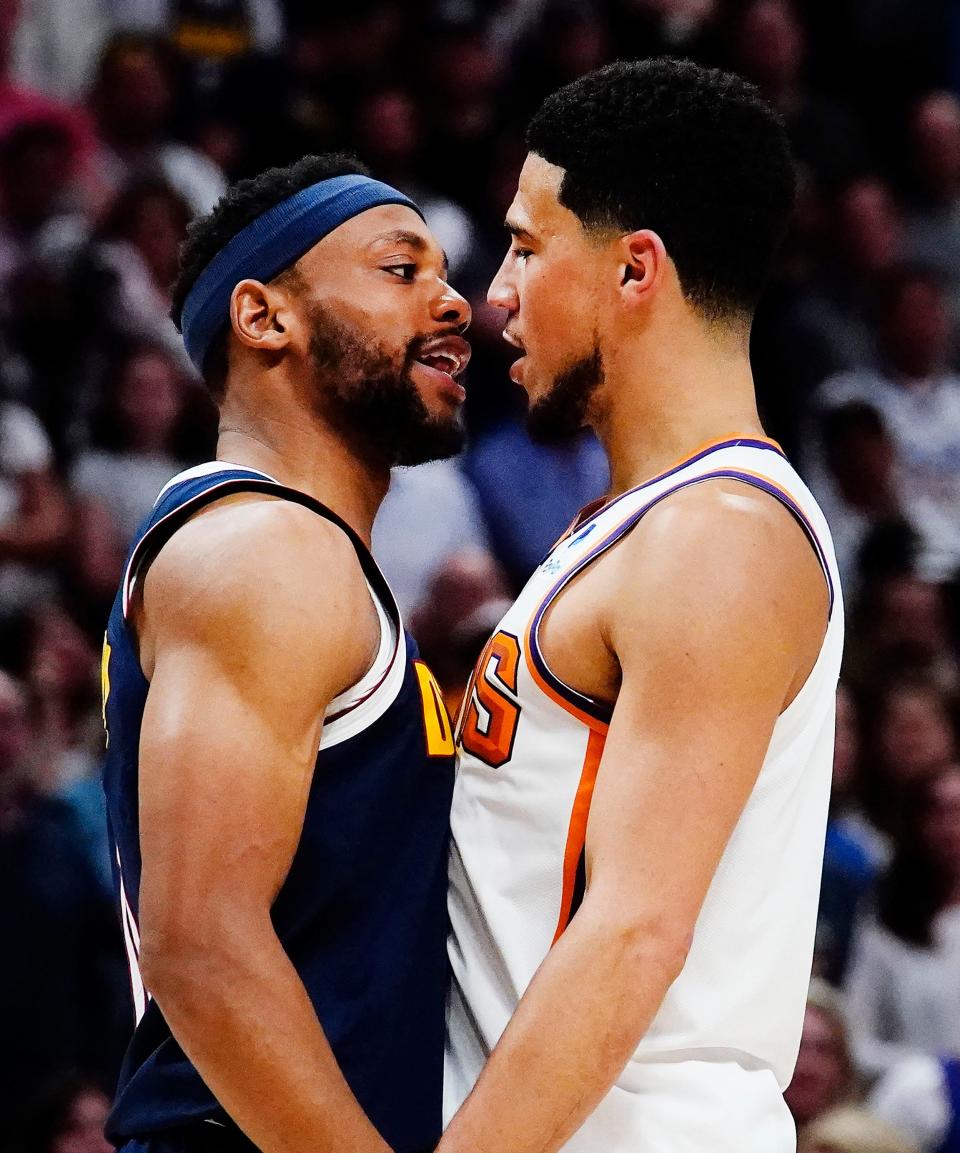 Denver Nuggets forward Bruce Brown (11) goes face-to-face with Phoenix Suns guard Devin Booker (1) in the fourth quarter during Game 2 of the Western Conference Semifinals at Ball Arena in Denver on May 1, 2023.