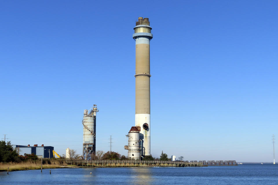 The smokestack at the former B.L. England power plant stand in Upper Township, N.J., before a control demolition, Thursday, Oct. 26, 2023. The site will be redeveloped as a mixed use residential and commercial project, and a nearby electrical substation will be used to connect New Jersey's soon-to-come offshore wind farms with the electrical grid. (AP Photo/Wayne Parry)