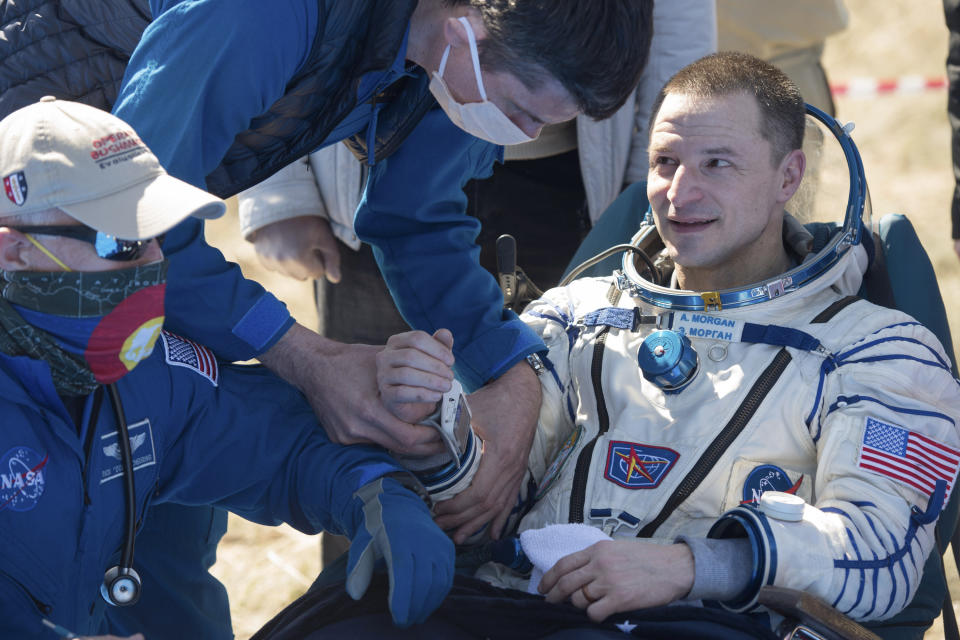 In this handout photo released by Gagarin Cosmonaut Training Centre (GCTC), Roscosmos space agency, U.S. astronaut Andrew Morgan gets assistance shortly after the landing of the Russian Soyuz MS-15 space capsule near Kazakh town of Dzhezkazgan, Kazakhstan, Friday, April 17, 2020. An International Space Station crew has landed safely after more than 200 days in space. The Soyuz capsule carrying NASA astronauts Andrew Morgan, Jessica Meir and Russian space agency Roscosmos' Oleg Skripochka touched down on Friday on the steppes of Kazakhstan. (Andrey Shelepin, Gagarin Cosmonaut Training Centre (GCTC), Roscosmos space agency, via AP)