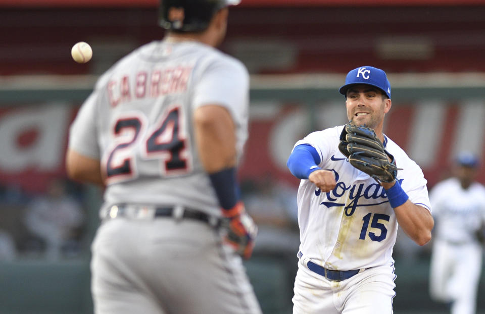 Kansas City Royals second baseman Whit Merrifield throws to first after forcing out Detroit Tigers' Miguel Cabrera at second, completing a double play on Eric Haase during the first inning of a baseball game in Kansas City, Mo., Tuesday, June 15, 2021. (AP Photo/Reed Hoffmann)