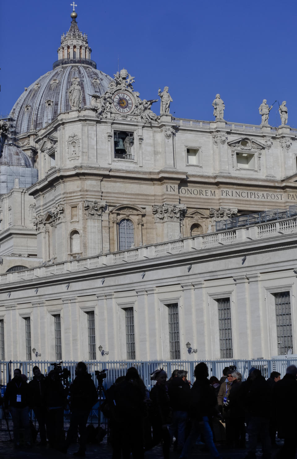 Journalists wait outside the Sant'Uffizio gate to the Vatican, Thursday, Feb. 21, 2019, before the start of a four-day sex abuse summit called by Pope Francis. The gathering of church leaders from around the globe is taking place amid intense scrutiny of the Catholic Church's record after new allegations of abuse and cover-up last year sparked a credibility crisis for the hierarchy. (AP Photo/Domenico Stinellis)