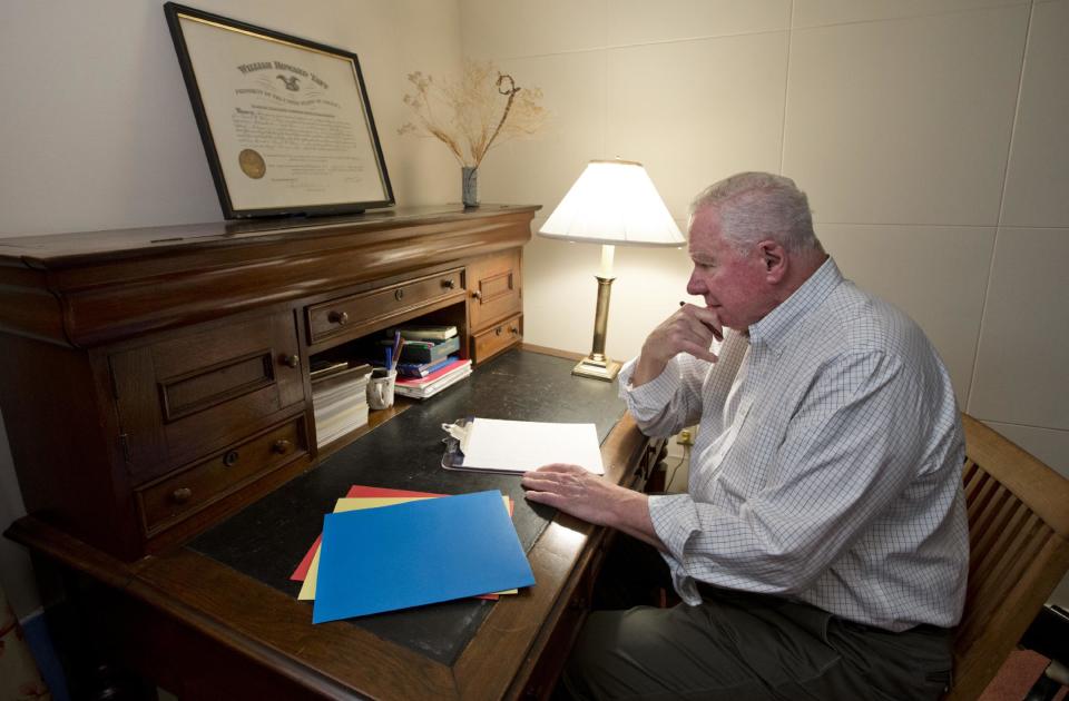 Sitting at a desk handed down from his grandfather, Dr. Paul Wilson, 80, a retired psychiatrist, recounts stories from his life which have become part of a memoir to share with his grandchildren about what his life was like, at his home in Bethesda, Md., Thursday, Oct. 4, 2012. Wilson expects his memoir to be roughly 60 pages when completed, plus some photographs and newspaper articles. He's considering having it self-published to produce a more polished final product. (AP Photo/J. Scott Applewhite)