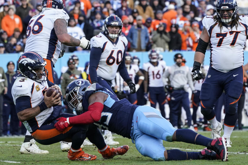 Tennessee Titans defensive end DeMarcus Walker (95) sacks Denver Broncos quarterback Russell Wilson (3) during the second half of an NFL football game, Sunday, Nov. 13, 2022, in Nashville, Tenn. (AP Photo/Mark Humphrey)