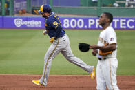 Milwaukee Brewers' Rowdy Tellez, left, rounds second after hitting a three-run home run off Pittsburgh Pirates starting pitcher Roansy Contreras, right, during the second inning of a baseball game in Pittsburgh, Friday, July 1, 2022. (AP Photo/Gene J. Puskar)