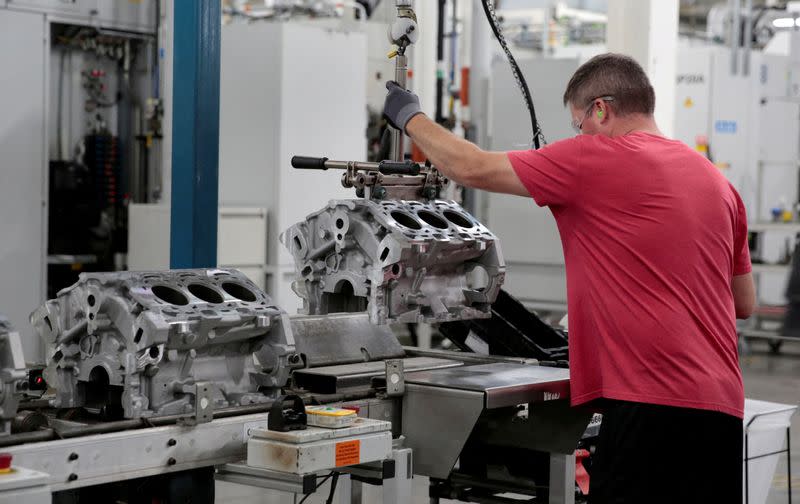 FILE PHOTO: A General Motors assembly worker loads engine block castings on to the assembly line at the GM Romulus Powertrain plant in Romulus,