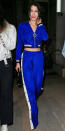 <p>The in-demand model was spotted out and about during Paris Fashion Week rocking a cropped electric blue track jacket and matching wide-leg track pants. She paired the chic pieces with a black leather handbag and heeled sandals.</p>