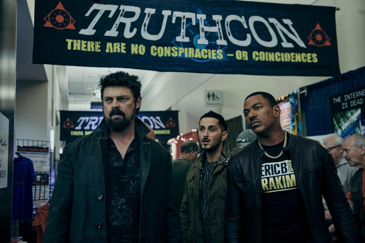 Butcher (Karl Urban, far left), Frenchie (Tomer Capone) and M.M. (Laz Alonso) hit up a convention for right-wing conspiracy theorists in "The Boys" Season 4."