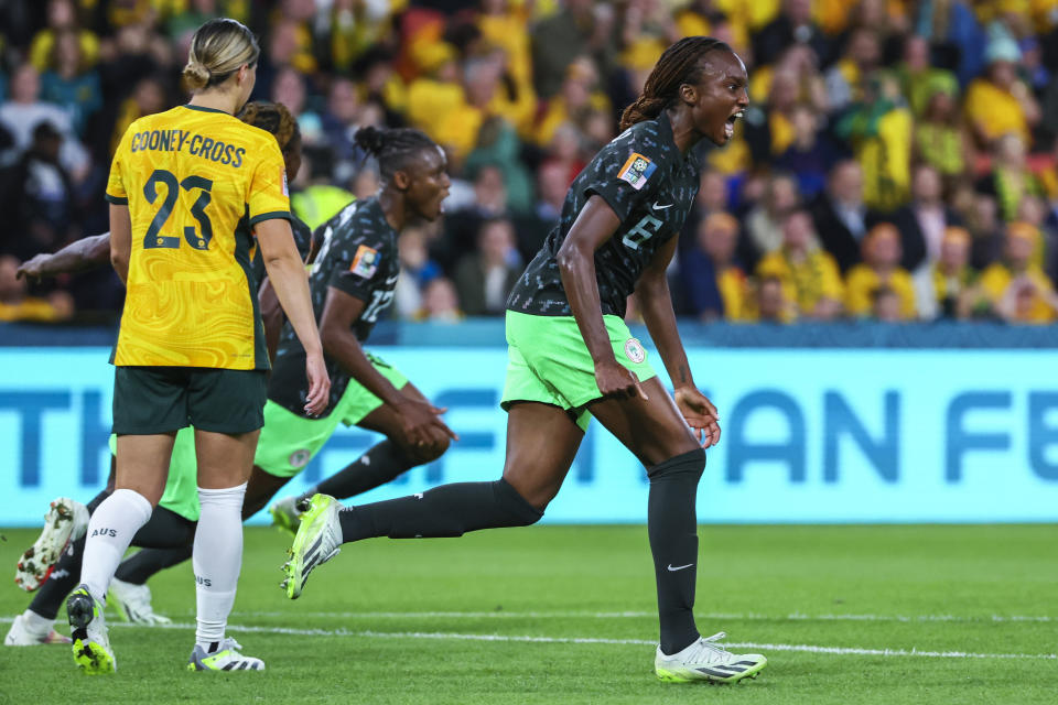 Nigeria's Ifeoma Onumonu, right, celebrates after teammate Uchenna Kanu, background, scored their side's first goal during the Women's World Cup Group B soccer match between Australia and Nigeria In Brisbane, Australia, Thursday, July 27, 2023. (AP Photo/Tertius Pickard)